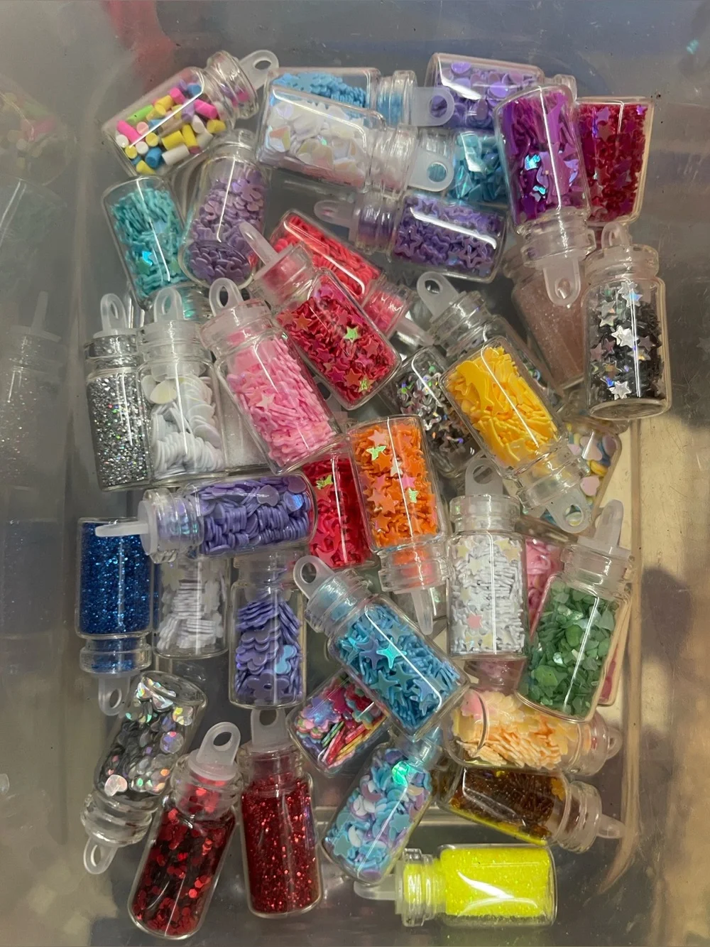 Around 40 jars of mini glitter and sequins